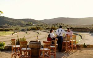 a group of people sitting at a table outside